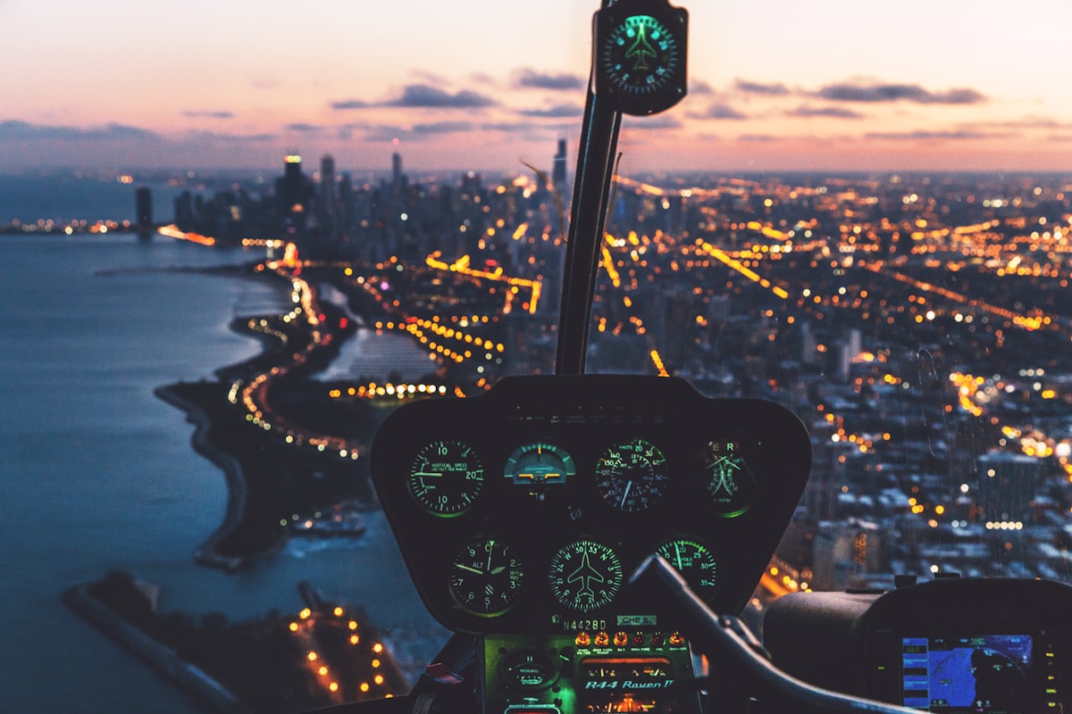 A helicopter cockpit above a city waterfront