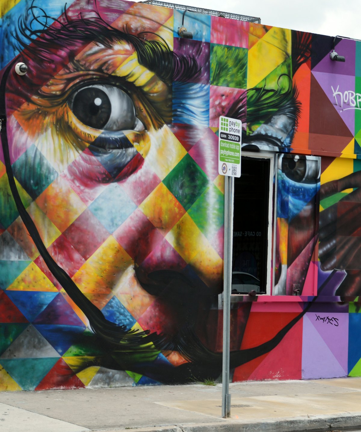 A bold yellow, green and red street-art mural